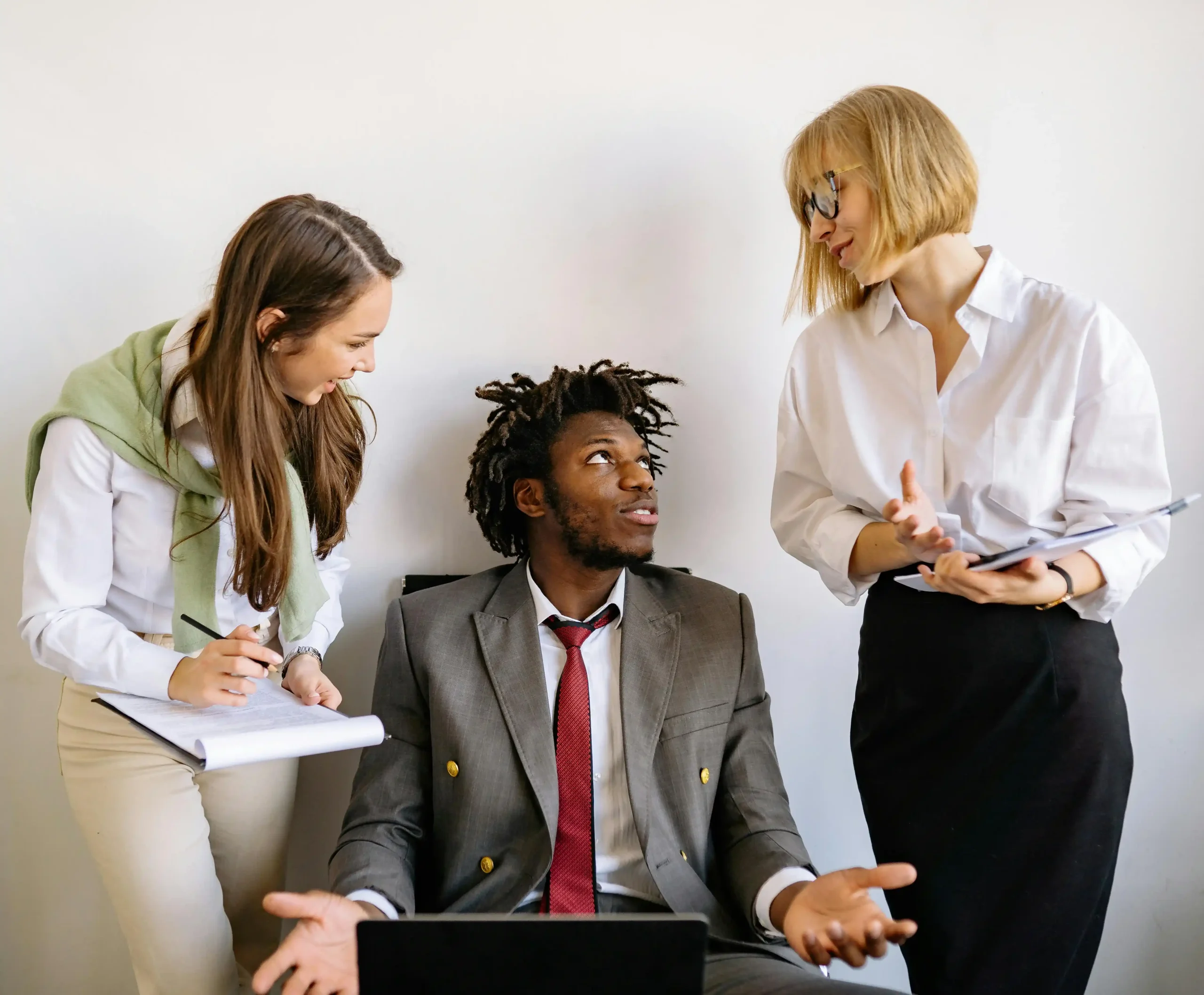 A diverse group of business professionals having a discussion in an office setting