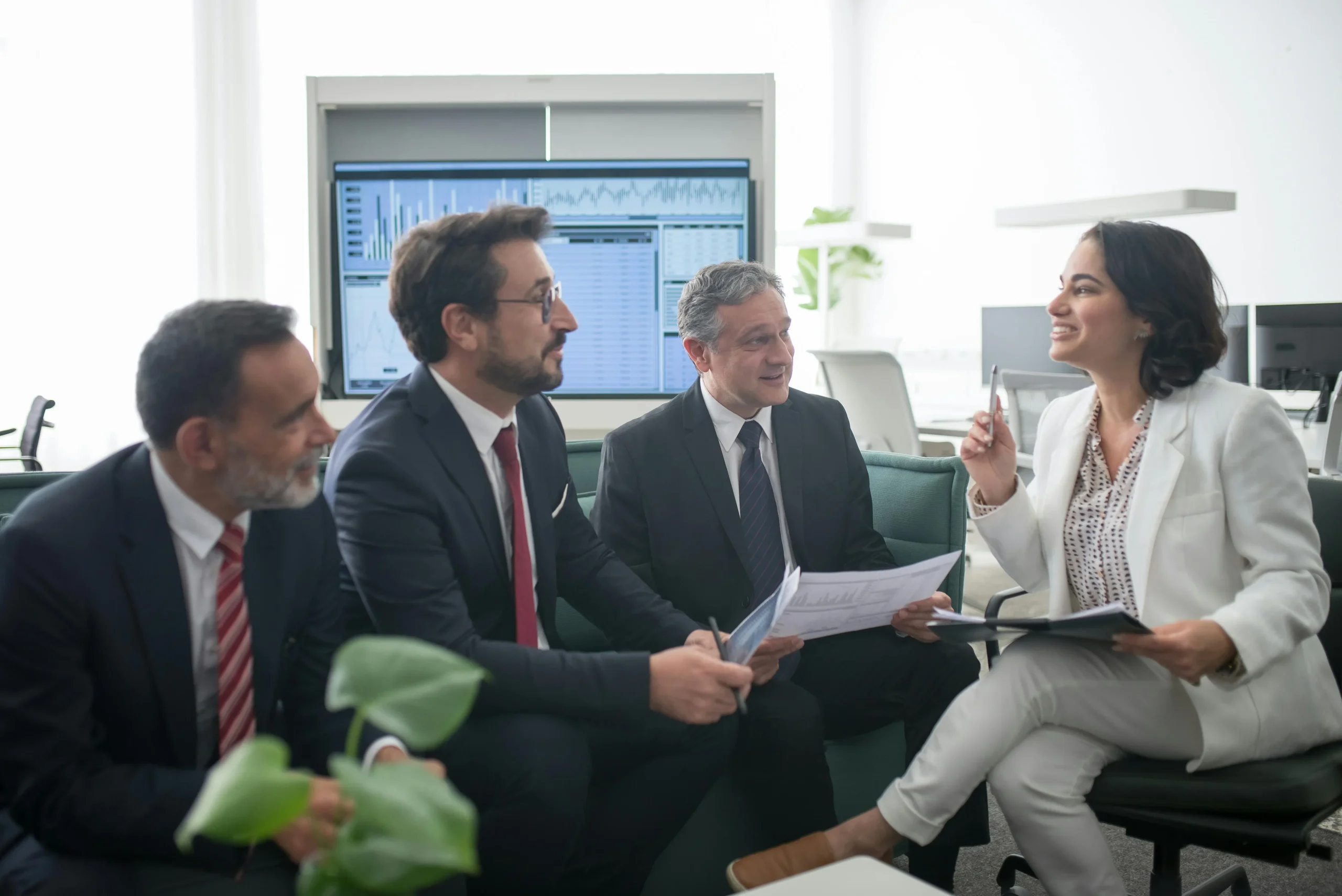 A group of business professionals having a discussion in a modern office setting